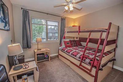 a bedroom with two bunk beds and a window at Lake Forest Glen # 117 By Hauserman Rentals in Tahoe City