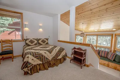 a bedroom with a bed and a wooden ceiling at KT22 View By Hauserman Rentals in Olympic Valley