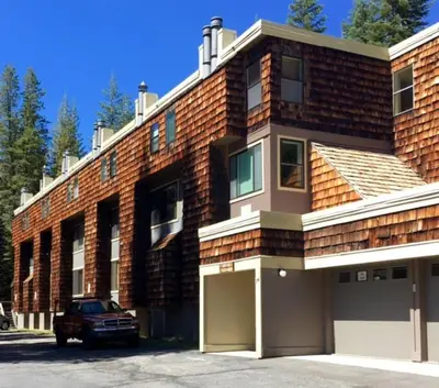 a brick building with a car parked in front of it at Cozy Condo with Fireplace - Tamarack 3 in Bear Valley