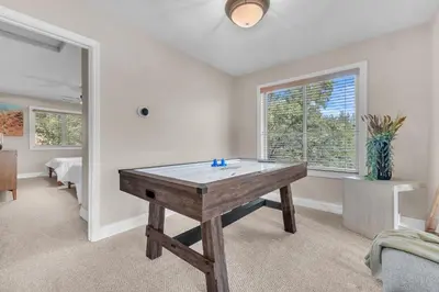 a room with a table in the middle of a room at Prasad Retreat - Sunny Home with Deck & Air Hockey home in Arnold