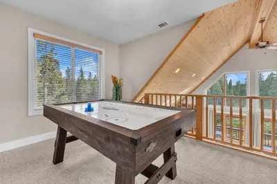 a pool table in a room with a balcony at Prasad Retreat - Sunny Home with Deck & Air Hockey home in Arnold