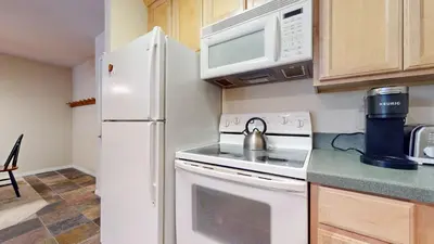 a kitchen with a white stove and a refrigerator at Summit #243 condo in Mammoth Lakes