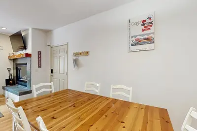 a dining room with a wooden table and chairs at Olympic Pines Lodge in Olympic Valley