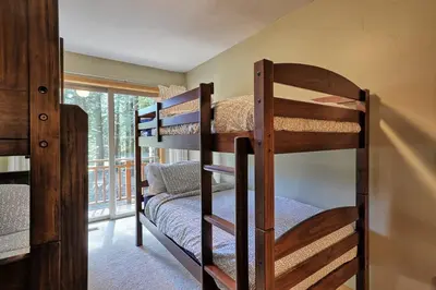 two bunk beds in a room with a window at Tahoma Family Home in Tahoma