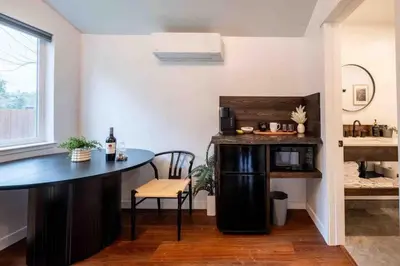a kitchen with a table and a chair in a room at Columbia Cabins Cabin 1 in Sonora