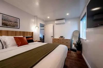 a bedroom with a large bed and a window at Columbia Cabins Cabin 1 in Sonora
