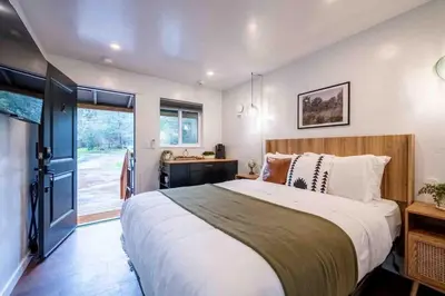 a bedroom with a large bed and a window at Columbia Cabins Cabin 2 in Sonora