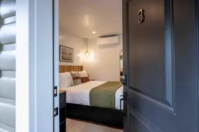 a bedroom with a bed and a door leading into a room at Columbia Cabins Cabin 3 in Sonora