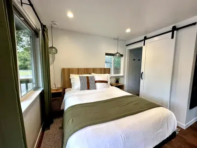 a bedroom with a large bed and a window at Columbia Cabins Cabin 5 in Sonora