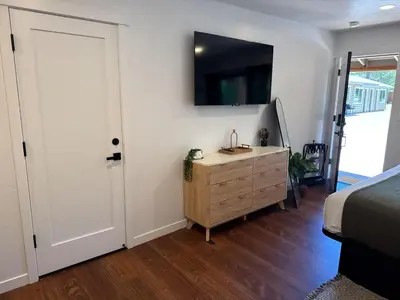 a bedroom with a bed and a dresser with a television at Columbia Cabins Cabin 6 in Sonora