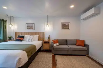 a bedroom with a bed and a couch at Columbia Cabins Cabin 6 in Sonora