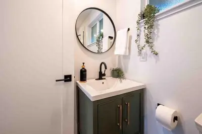 a bathroom with a sink and a mirror at Columbia Cabins Cabin 7 in Sonora