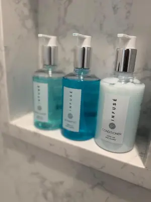 three bottles ofodorizers sitting on a shelf in a bathroom at Columbia Cabins Cabin 7 in Sonora