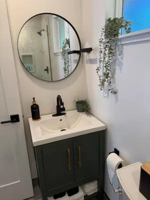a bathroom with a sink and a mirror at Columbia Cabins Cabin 7 in Sonora