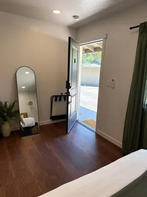 a room with a mirror and a bed and a door at Columbia Cabins Cabin 8 in Sonora