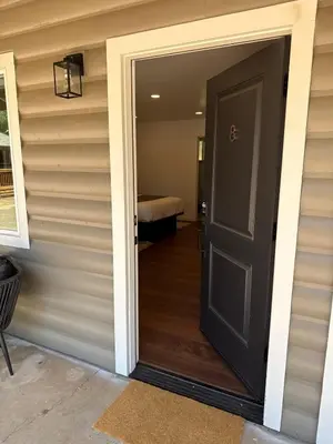 a door leading to a room with a bed at Columbia Cabins Cabin 8 in Sonora