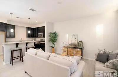 a living room with two couches and a kitchen at Local 3BD 3BA with WiFi Parking in Carson City