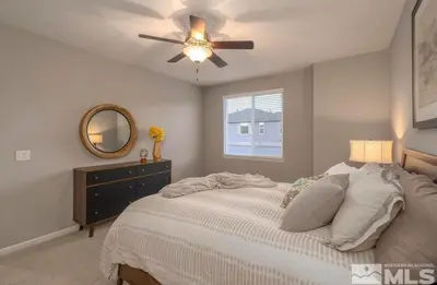 a bedroom with a bed and a ceiling fan at Local 3BD 3BA with WiFi Parking in Carson City