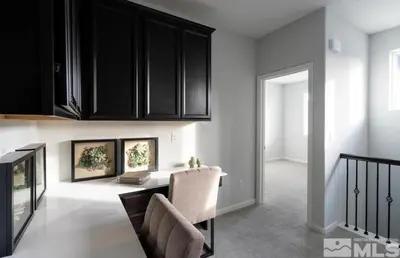 a kitchen with black cabinets and a dining room at Local 3BD 3BA with WiFi Parking in Carson City