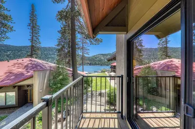 a house with a balcony with a view of a lake at Spacious 1BR Condo #218 at Donner Lake Village in Truckee