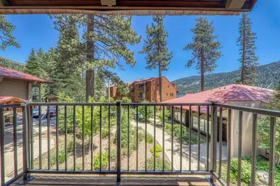 a view from the balcony of a house with trees at Spacious 1BR Condo #218 at Donner Lake Village in Truckee