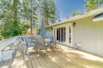 a deck with a table and chairs and an umbrella at Truckee Mountain Retreat Family Friendly 3BR 2BA in Truckee