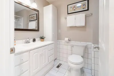 a white bathroom with a toilet and a sink at Truckee Mountain Retreat Family Friendly 3BR 2BA in Truckee