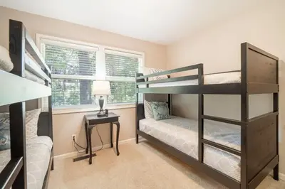 a bedroom with two bunk beds and a desk at Truckee Mountain Retreat Family Friendly 3BR 2BA in Truckee