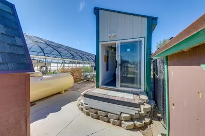 a small building with a glass door in a yard at 11 Mi to Heavenly Resort Pet-Friendly Tiny Home in Gardnerville