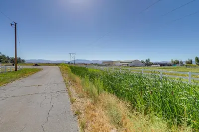 an empty road next to a field of tall grass at 11 Mi to Heavenly Resort Pet-Friendly Tiny Home in Gardnerville