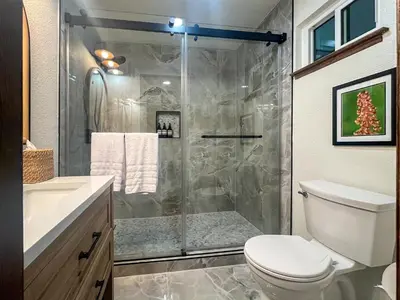 a bathroom with a shower and a toilet at Yosemite Family Lodge I Sleeps 11 I Game Room in Oakhurst