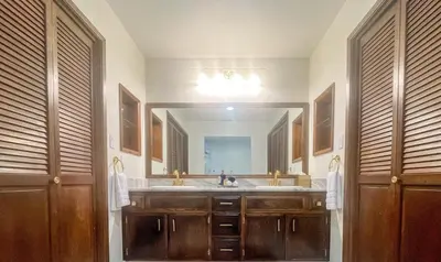 a bathroom with a sink and a large mirror at Yosemite Family Lodge I Sleeps 11 I Game Room in Oakhurst