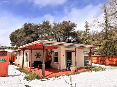 a small house with a red roof in the snow at Sam's Place Mariposa - In Town! in Mariposa