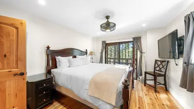 a bedroom with a bed and a flat screen tv at Secluded Incline Village Stay w Deck Near Diamond Peak Lake Cloud 9 and 12 by AvantStay in Incline Village