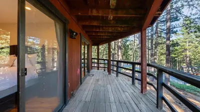 a wrap around porch of a cabin with glass doors at Secluded Incline Village Stay w Deck Near Diamond Peak Lake Cloud 9 and 12 by AvantStay in Incline Village