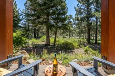 a bottle of wine sitting on a table on a porch at Solstice 8 in Mammoth Lakes
