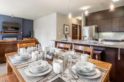 a dining room table with plates and dishes on it at Solstice 8 in Mammoth Lakes