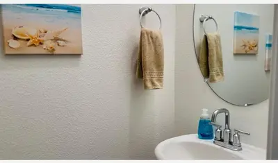 a bathroom with a sink and a mirror at Spacious, bright and cozy space