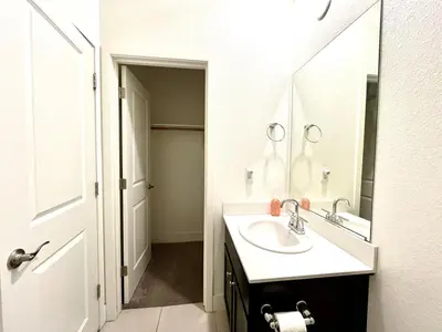 a white bathroom with a sink and a mirror at Spacious, bright and cozy space