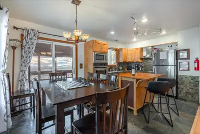 a kitchen with a table and chairs and a refrigerator at Lakeside Serenity Retreat in Kings Beach