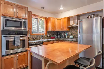 a kitchen with stainless steel appliances and a wooden counter top at Lakeside Serenity Retreat in Kings Beach