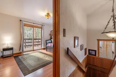 a living room with a stairway leading to a door at Lakeside Serenity Retreat in Kings Beach