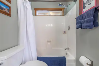 a bathroom with a white toilet and a shower at Lakeside Serenity Retreat in Kings Beach