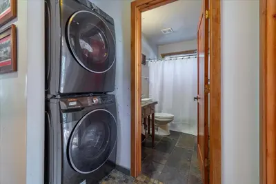 a bathroom with a washing machine and a washer and dryer at Lakeside Serenity Retreat in Kings Beach