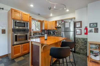 a kitchen with wooden cabinets and a wooden counter top at Lakeside Serenity Retreat in Kings Beach
