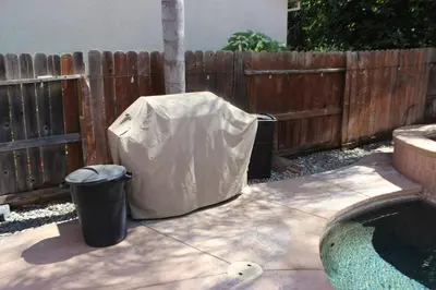 a cover over a trash can next to a fence at Luxurious 5-Bedroom Retreat with Saltwater Pool and Spa in Elk Grove