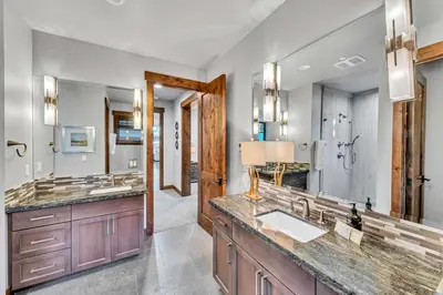 a bathroom with a sink and a large mirror at Schaffers Mill Escape Golf Views and Near Skiing in Truckee