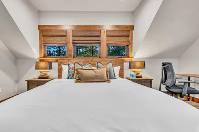 a bedroom with a large white bed and two lamps at Schaffers Mill Escape Golf Views and Near Skiing in Truckee