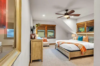 a bedroom with a bed and a ceiling fan at Schaffers Mill Escape Golf Views and Near Skiing in Truckee