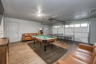 a room with two ping pong tables and a couch at Clovis Retreat Hottub & Firepit in Clovis